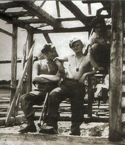 Young Karol Wojtya as a young factory worker and wearing a brown scapular. 