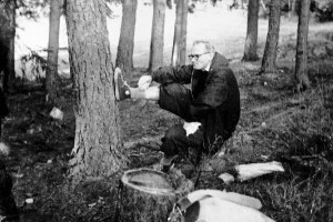 Fr. Karol Wojtyla rocking the sneakers (maybe Chuck Taylors) and eating a pastry. 