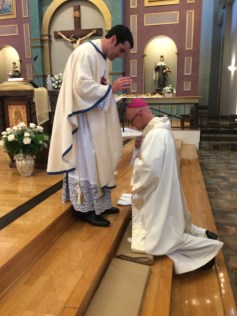 Newly ordained, Fr. Ryan Lee, blessing Bishop James Wall of the Diocese of Gallup.