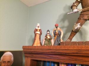 The Magi start on the top of my bookcase after talking with Pope Benedict and the Knight. 